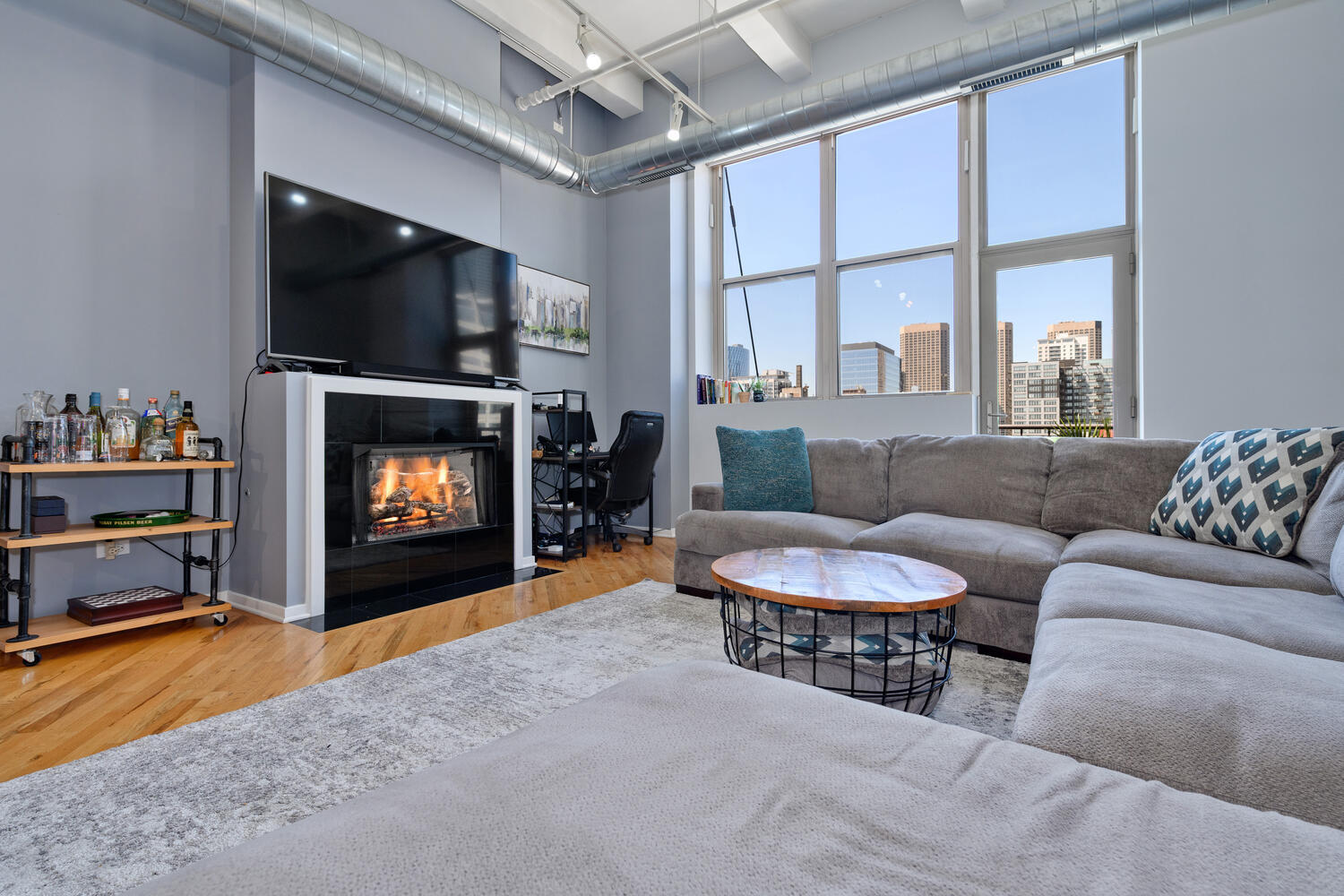 500 South Clinton Street, Unit 841 Chicago, IL 60607 - Photo 4 of 22 a living room with furniture a flat screen tv and a fireplace