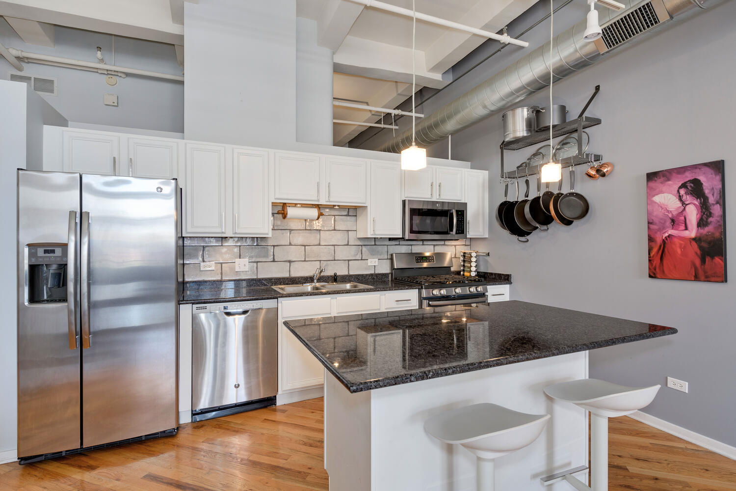 500 South Clinton Street, Unit 841 Chicago, IL 60607 - Photo 8 of 22 a kitchen with stainless steel appliances granite countertop a sink a stove and a refrigerator