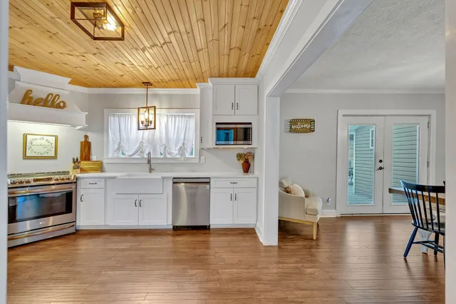a kitchen with a stove a sink and a refrigerator
