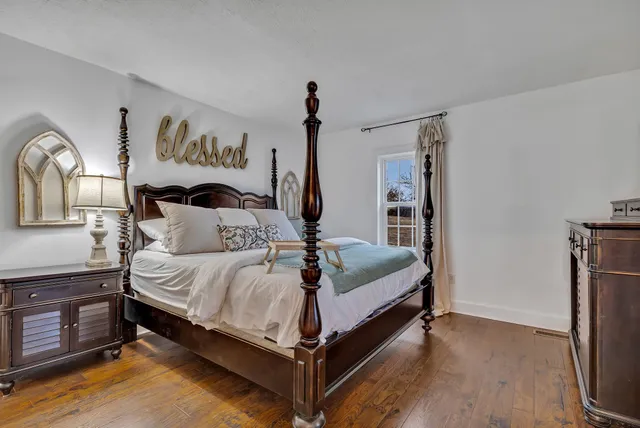 a bed room with a bed and a night stand