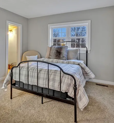 a bedroom with a bed and a table in it