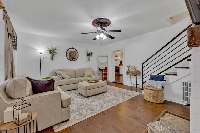 a living room with furniture and wooden floor