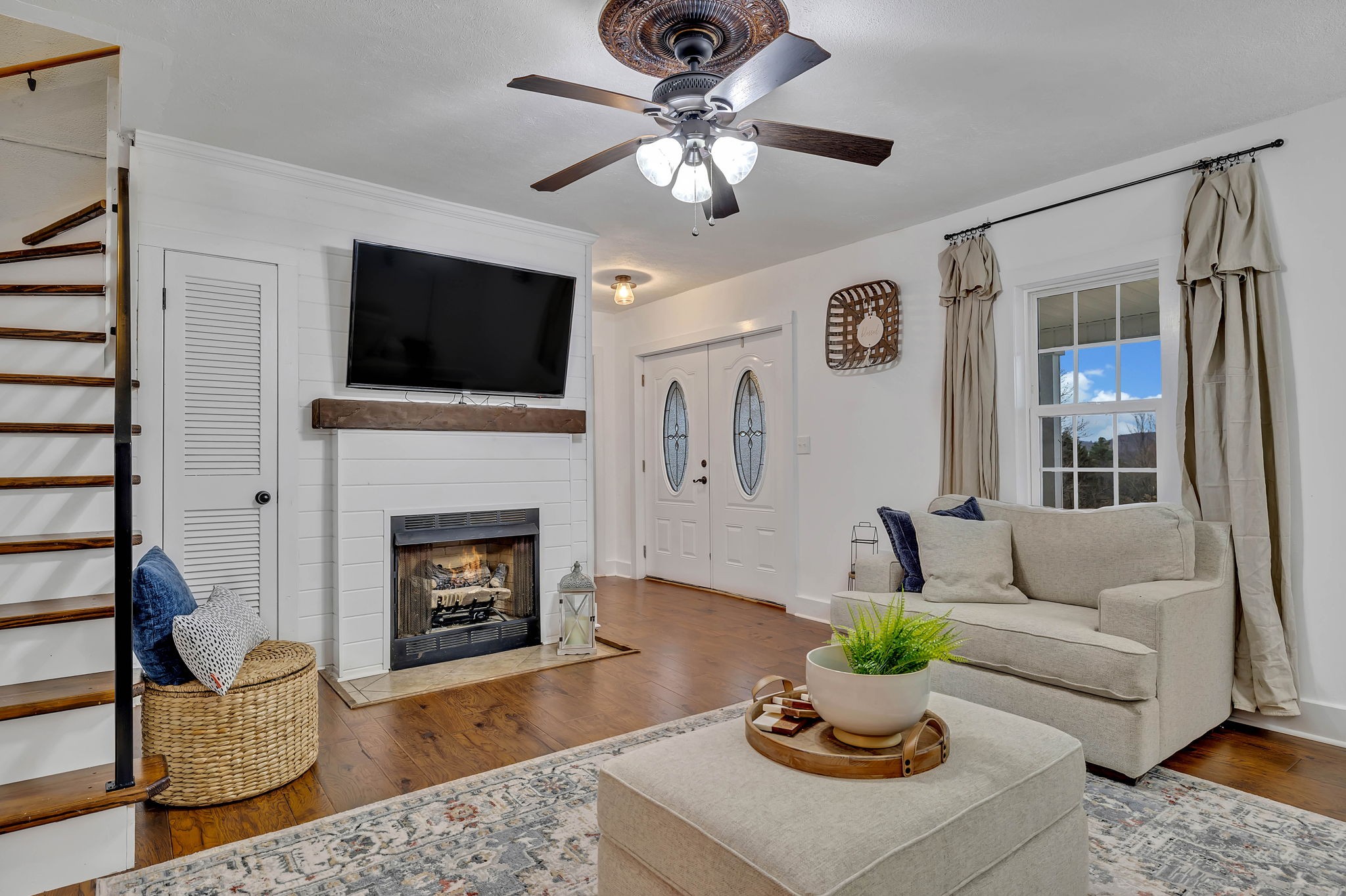 3132 Fishing Ford Road Petersburg, TN 37144 - Photo 10 of 36 a living room with furniture a flat screen tv and a fireplace