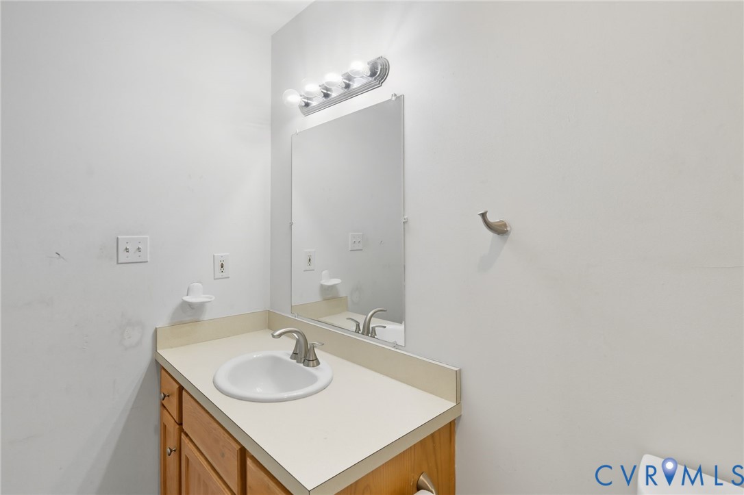 117 Pleasant Spring Avenue Waverly, VA 23890 - Photo 15 of 17 a bathroom with a sink and a mirror