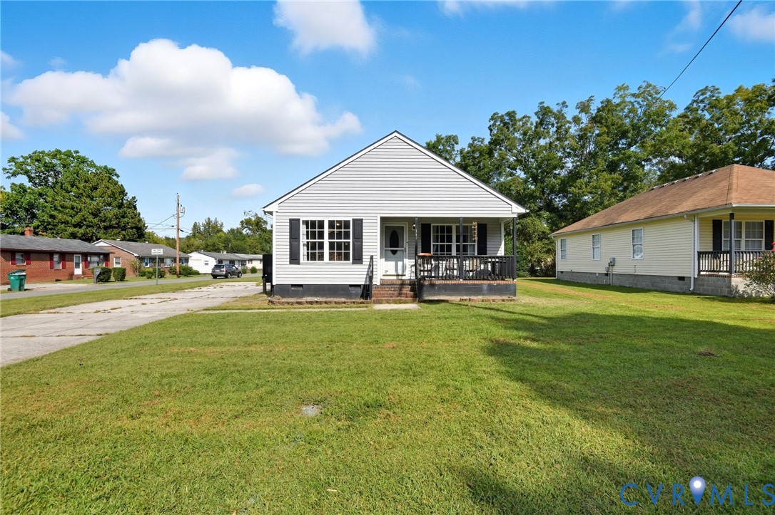 117 Pleasant Spring Avenue Waverly, VA 23890 - Photo 3 of 17 a front view of a house with a yard table and chairs