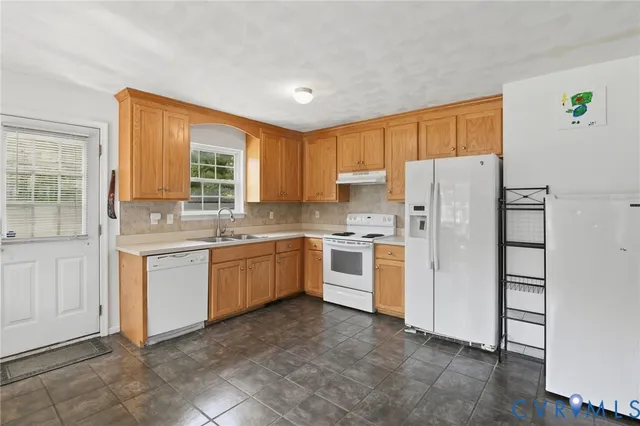 a kitchen with a refrigerator and window
