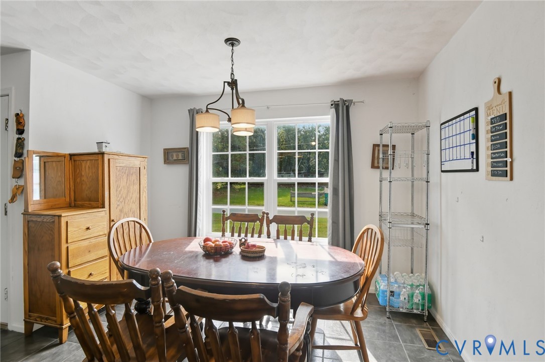 117 Pleasant Spring Avenue Waverly, VA 23890 - Photo 10 of 17 a view of a dining room with furniture window and wooden floor