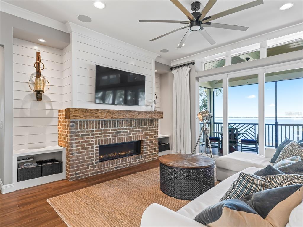 12943 Southeast Sunset Harbor Road Weirsdale, FL 32195 - Photo 12 of 87 a living room with furniture and a fireplace