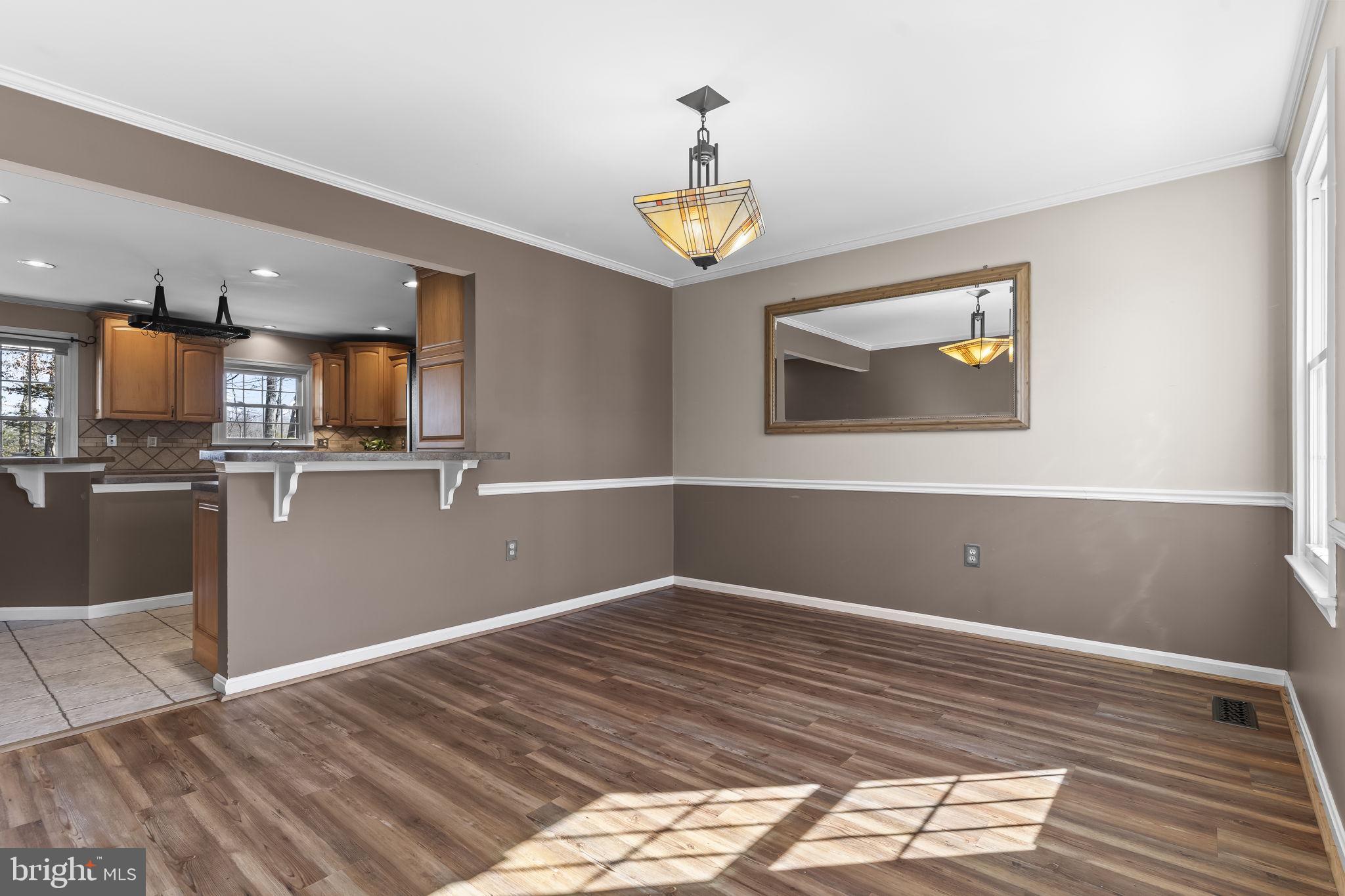 11460 La Plata Road La Plata, MD 20646 - Photo 12 of 51 a view of a kitchen with wooden floor and a ceiling fan