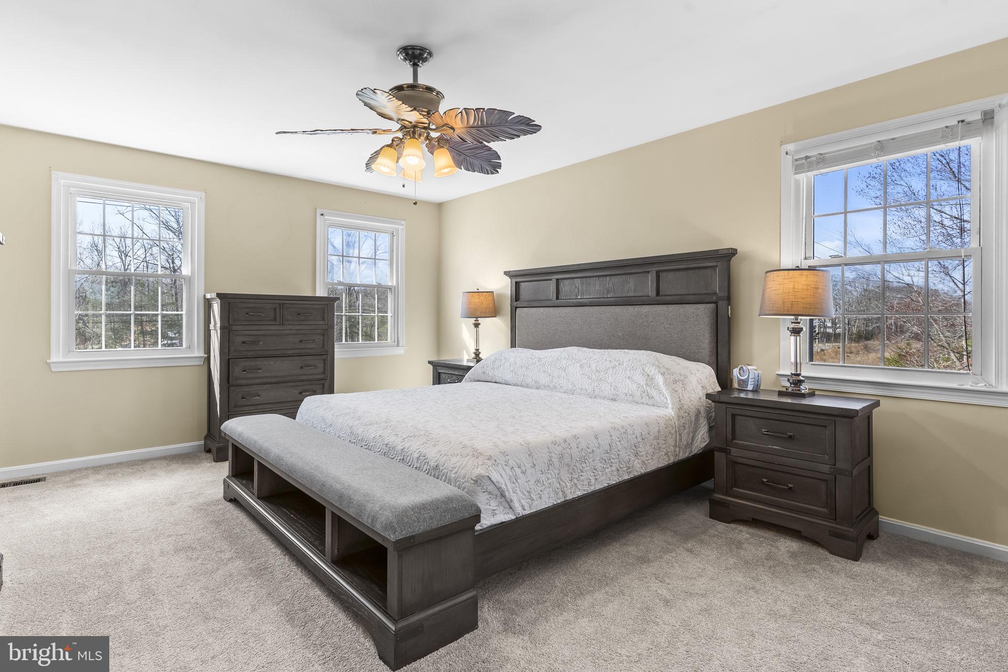 11460 La Plata Road La Plata, MD 20646 - Photo 18 of 51 a bedroom with a bed and a chandelier