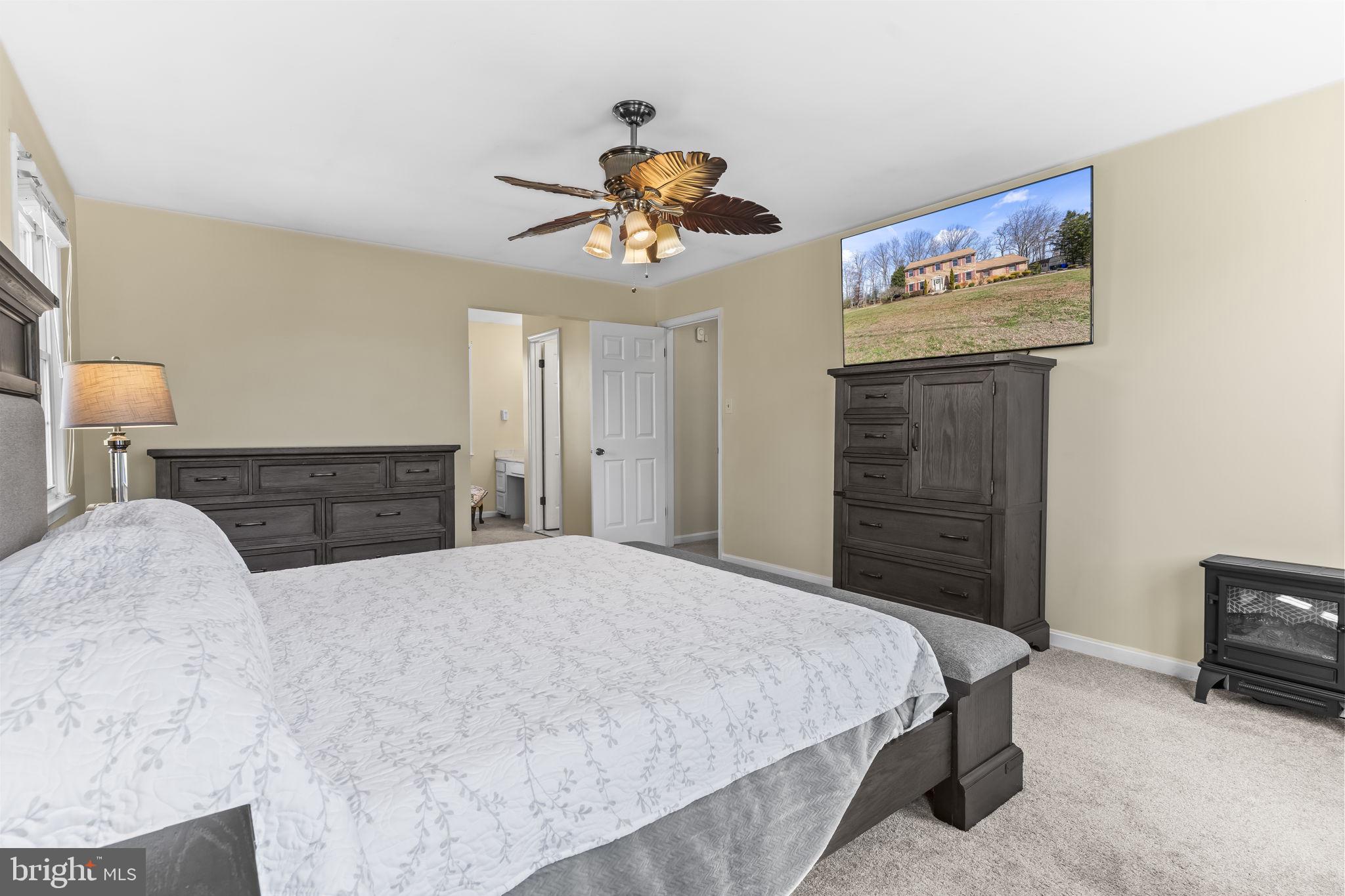 11460 La Plata Road La Plata, MD 20646 - Photo 19 of 51 a bedroom with a bed and a chandelier