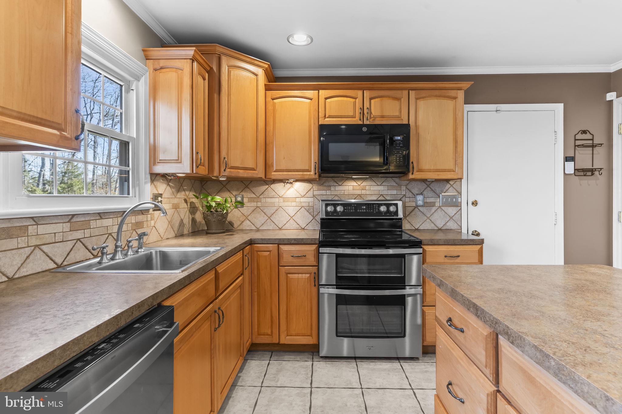 11460 La Plata Road La Plata, MD 20646 - Photo 2 of 51 a kitchen with a sink stove and microwave