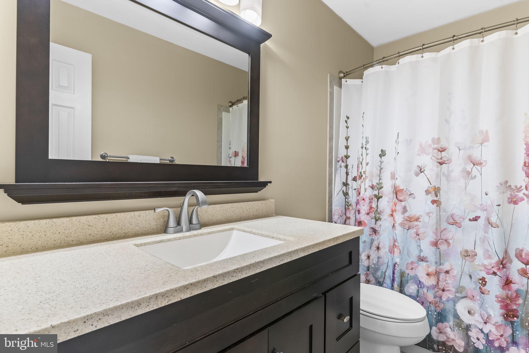 11460 La Plata Road La Plata, MD 20646 - Photo 29 of 51 a bathroom with a granite countertop sink a toilet and a mirror