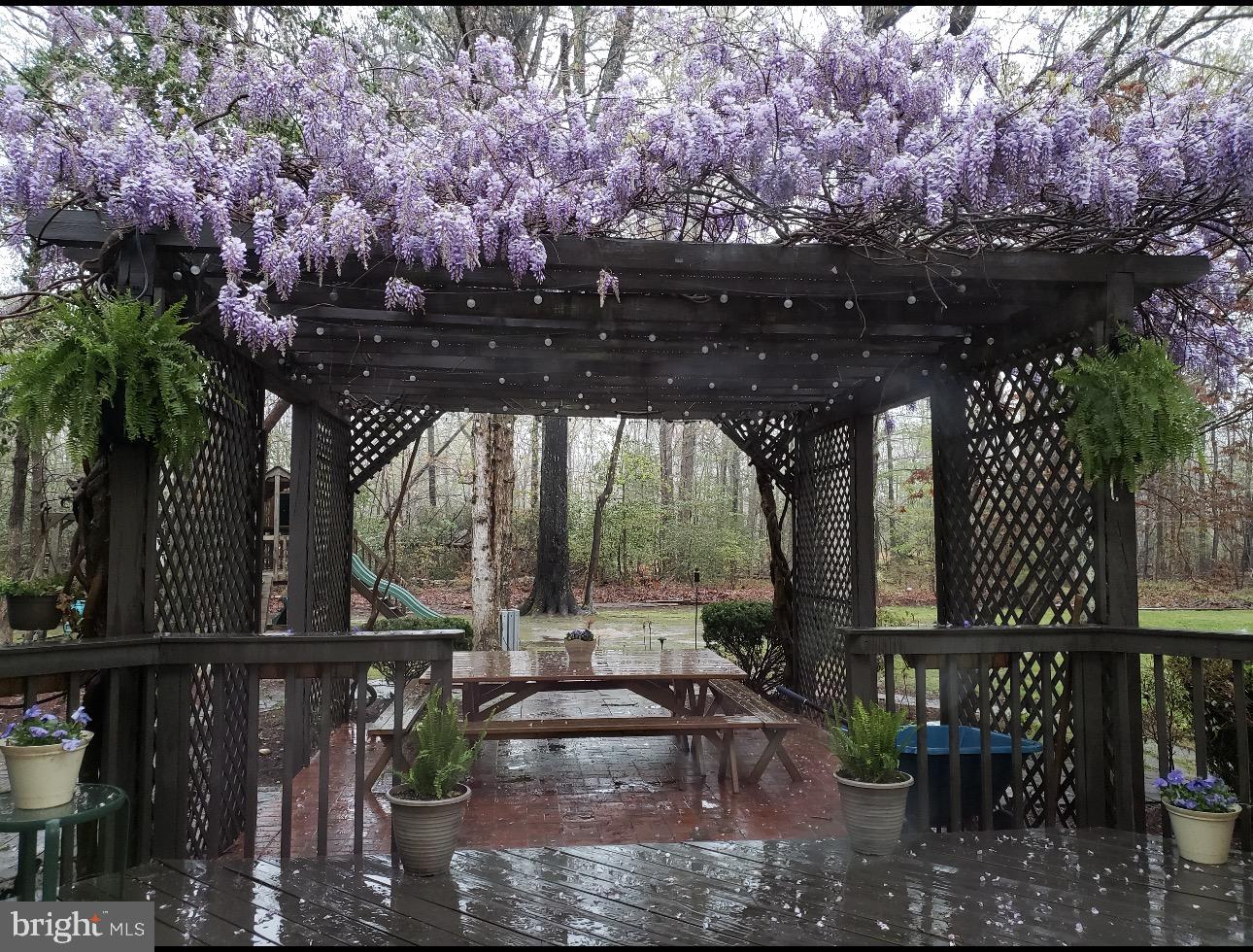 11460 La Plata Road La Plata, MD 20646 - Photo 30 of 51 a view of a patio with table and chairs and potted plants