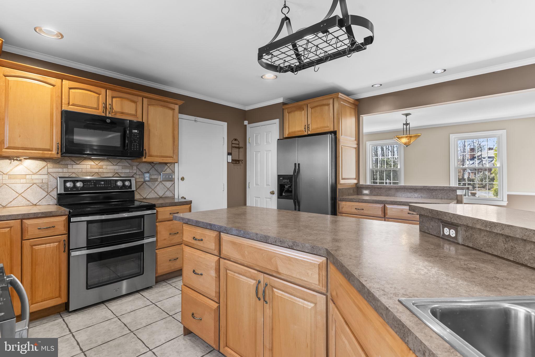 11460 La Plata Road La Plata, MD 20646 - Photo 3 of 51 a kitchen with stainless steel appliances granite countertop a sink and a stove