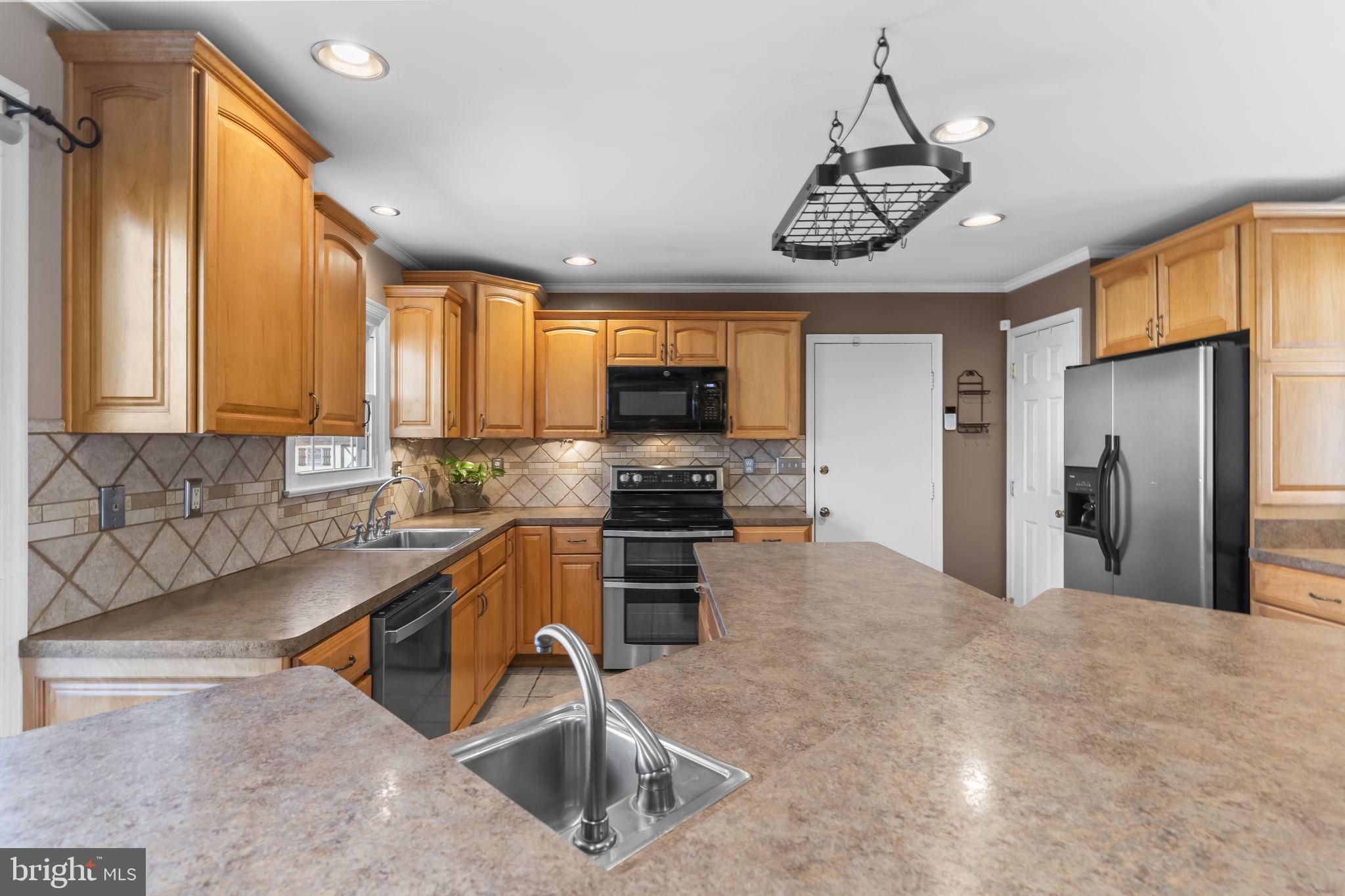 11460 La Plata Road La Plata, MD 20646 - Photo 4 of 51 a kitchen with stainless steel appliances granite countertop a sink a stove and cabinets