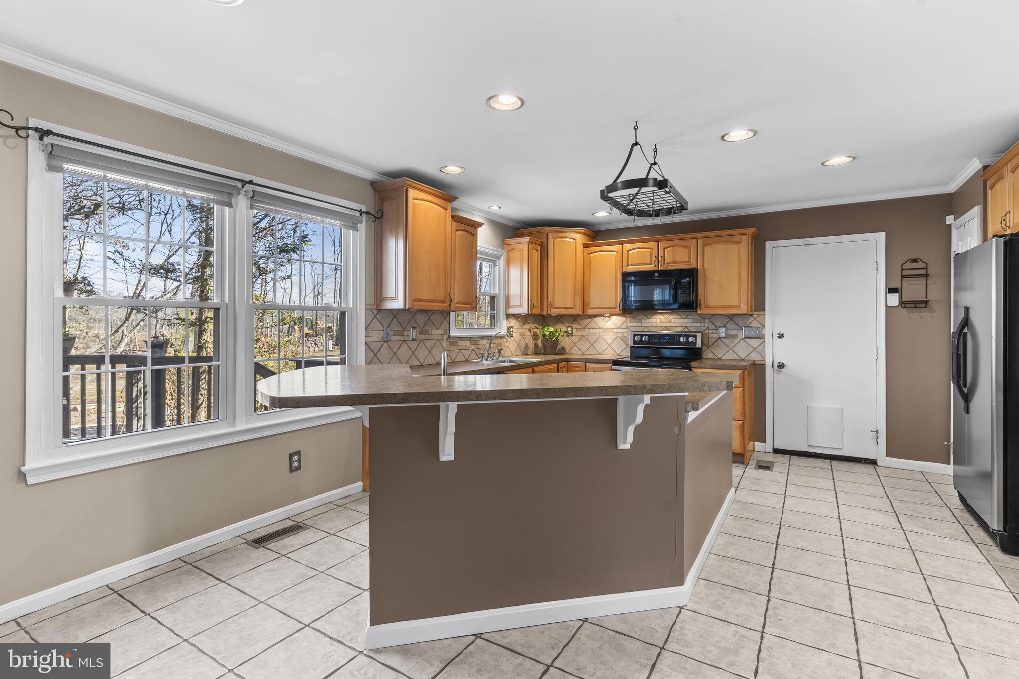 11460 La Plata Road La Plata, MD 20646 - Photo 5 of 51 a kitchen with stainless steel appliances granite countertop a stove a sink and a refrigerator