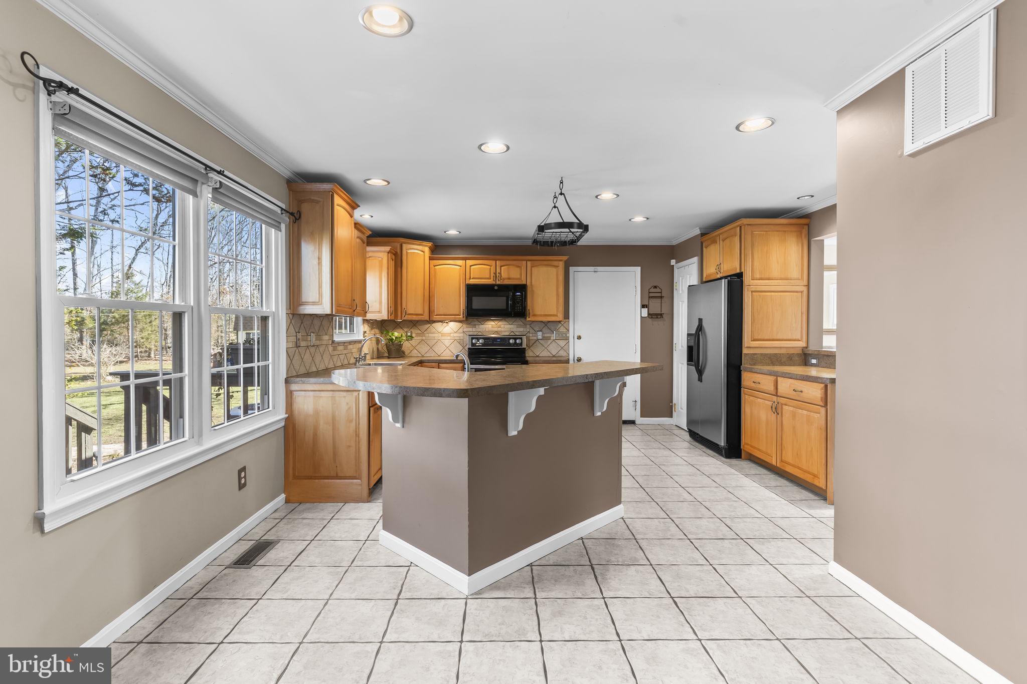 11460 La Plata Road La Plata, MD 20646 - Photo 6 of 51 a kitchen with stainless steel appliances granite countertop a refrigerator and a stove top oven
