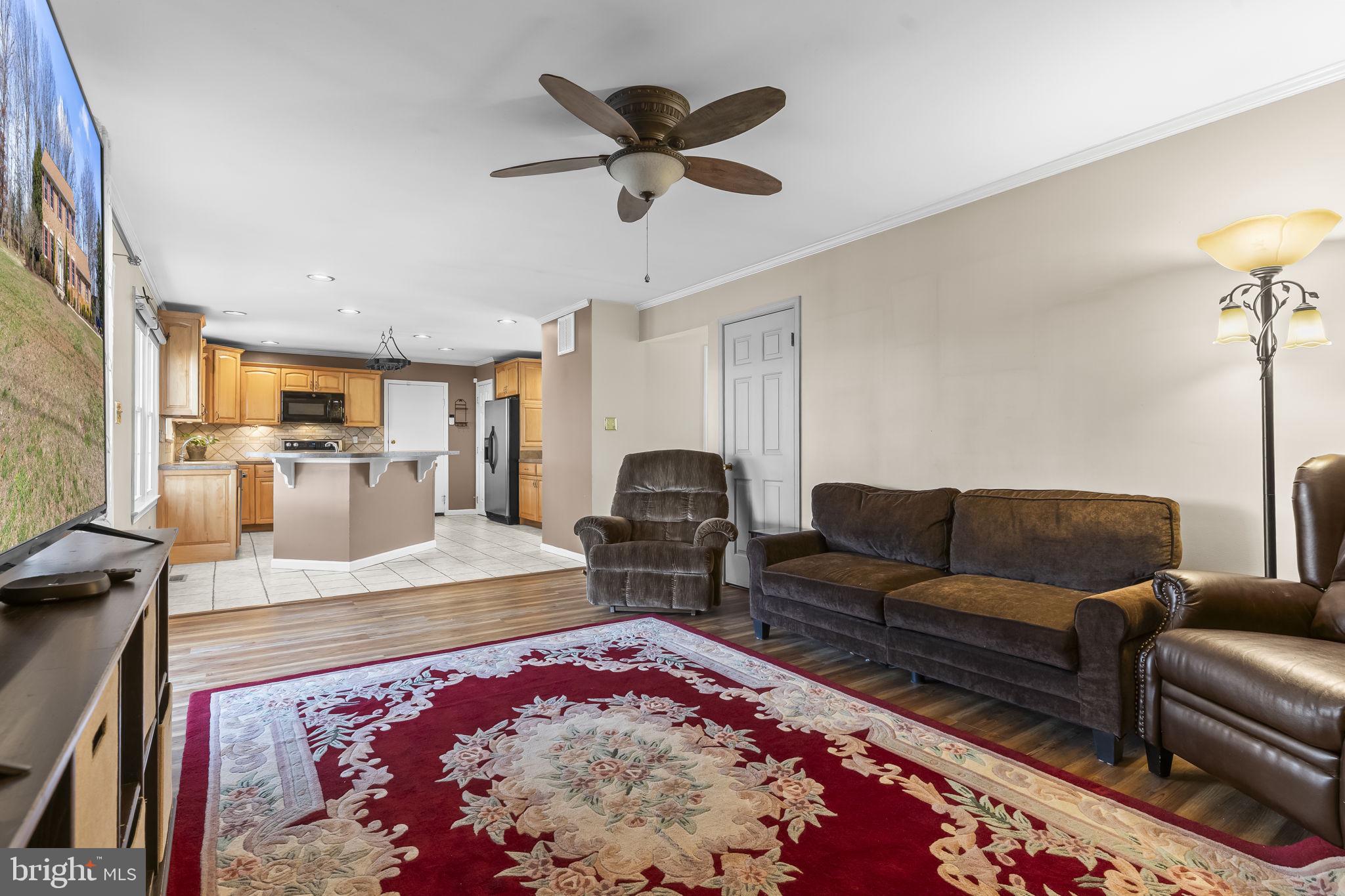11460 La Plata Road La Plata, MD 20646 - Photo 9 of 51 a living room with furniture flat screen tv and a table