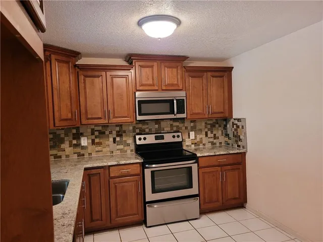 a kitchen with a stove and a microwave