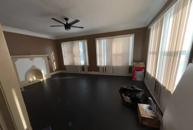 a view of wooden floor and windows in a room