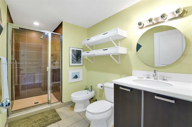 a bathroom with a mirror sink and toilet
