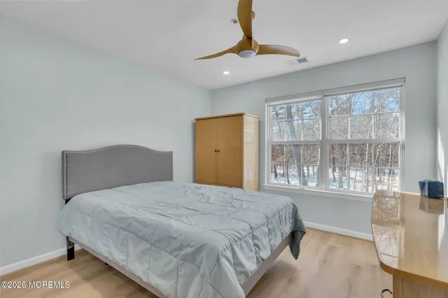 a bedroom with a large bed and a large window