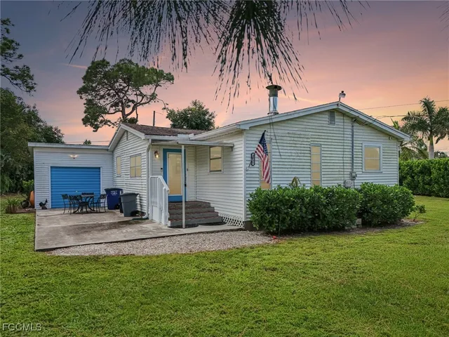 a front view of house with yard and outdoor seating