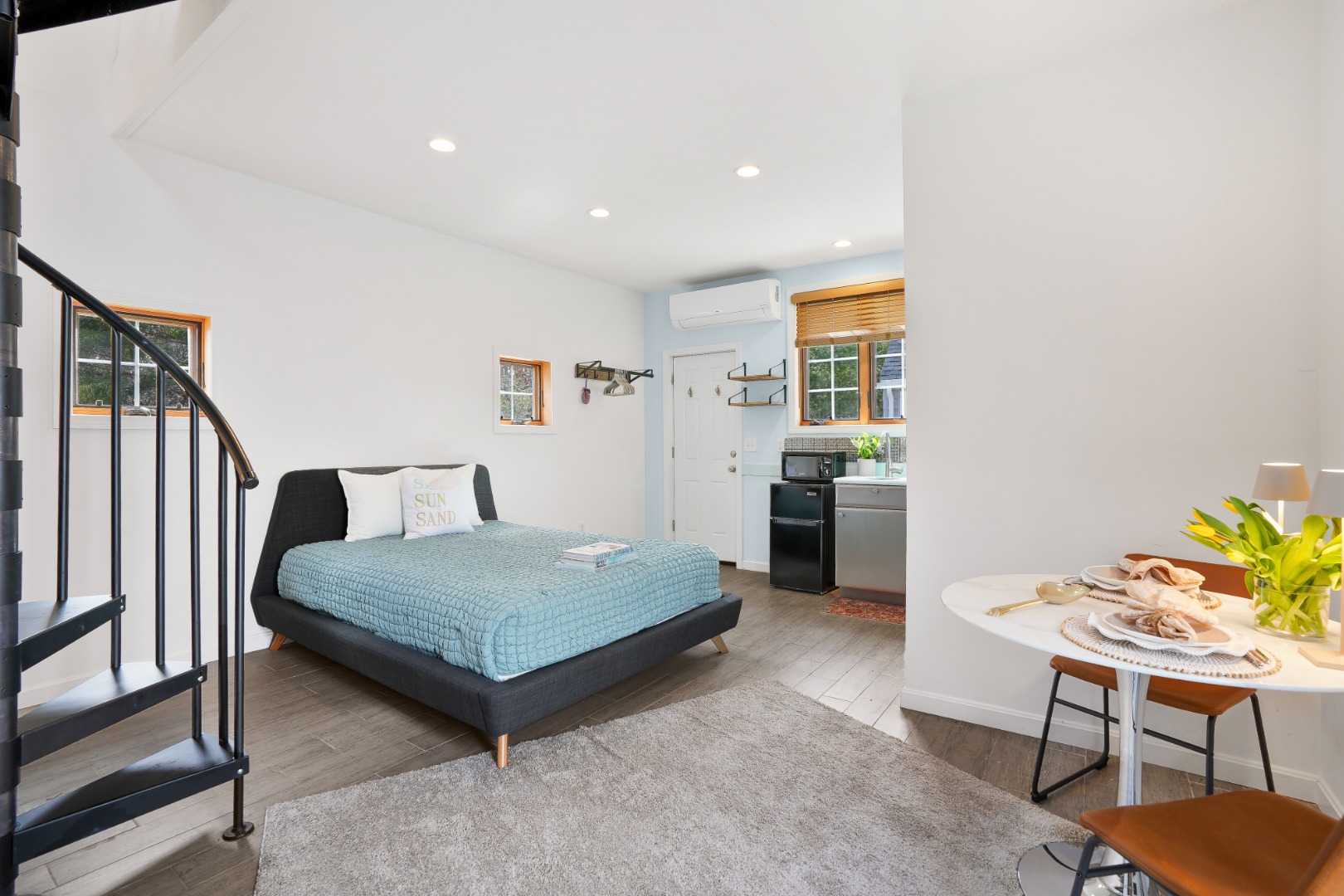 26 Sea Glen Road Oak Bluffs, MA 02557 - Photo 25 of 36 a bedroom with a bed and a table in it