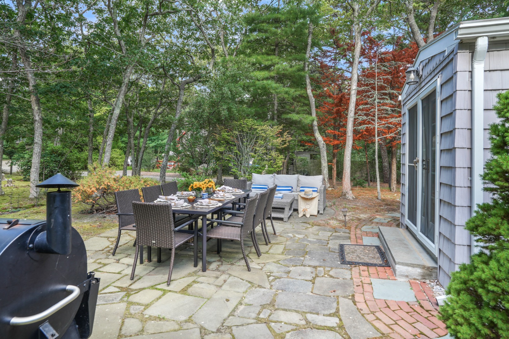 26 Sea Glen Road Oak Bluffs, MA 02557 - Photo 32 of 36 a view of a patio with a table and chairs