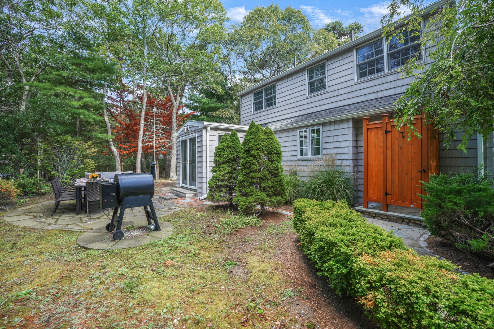26 Sea Glen Road Oak Bluffs, MA 02557 - Photo 33 of 36 a backyard of a house with outdoor seating