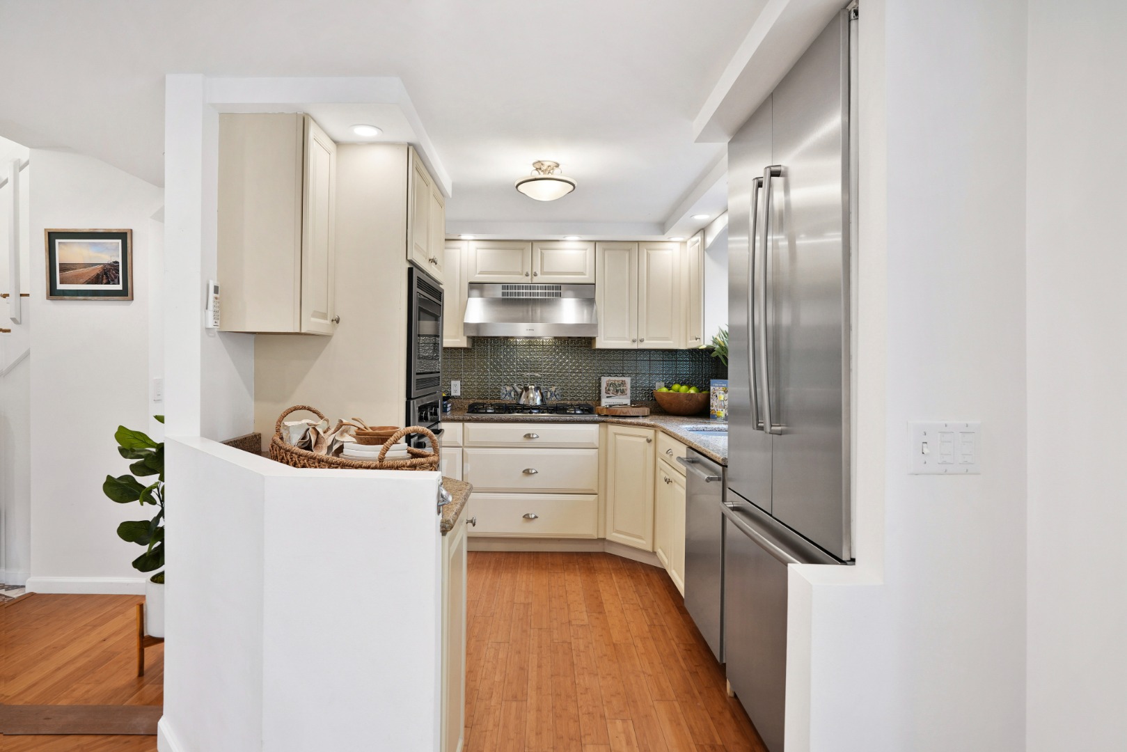 26 Sea Glen Road Oak Bluffs, MA 02557 - Photo 9 of 36 a kitchen with stainless steel appliances a refrigerator sink and white cabinets