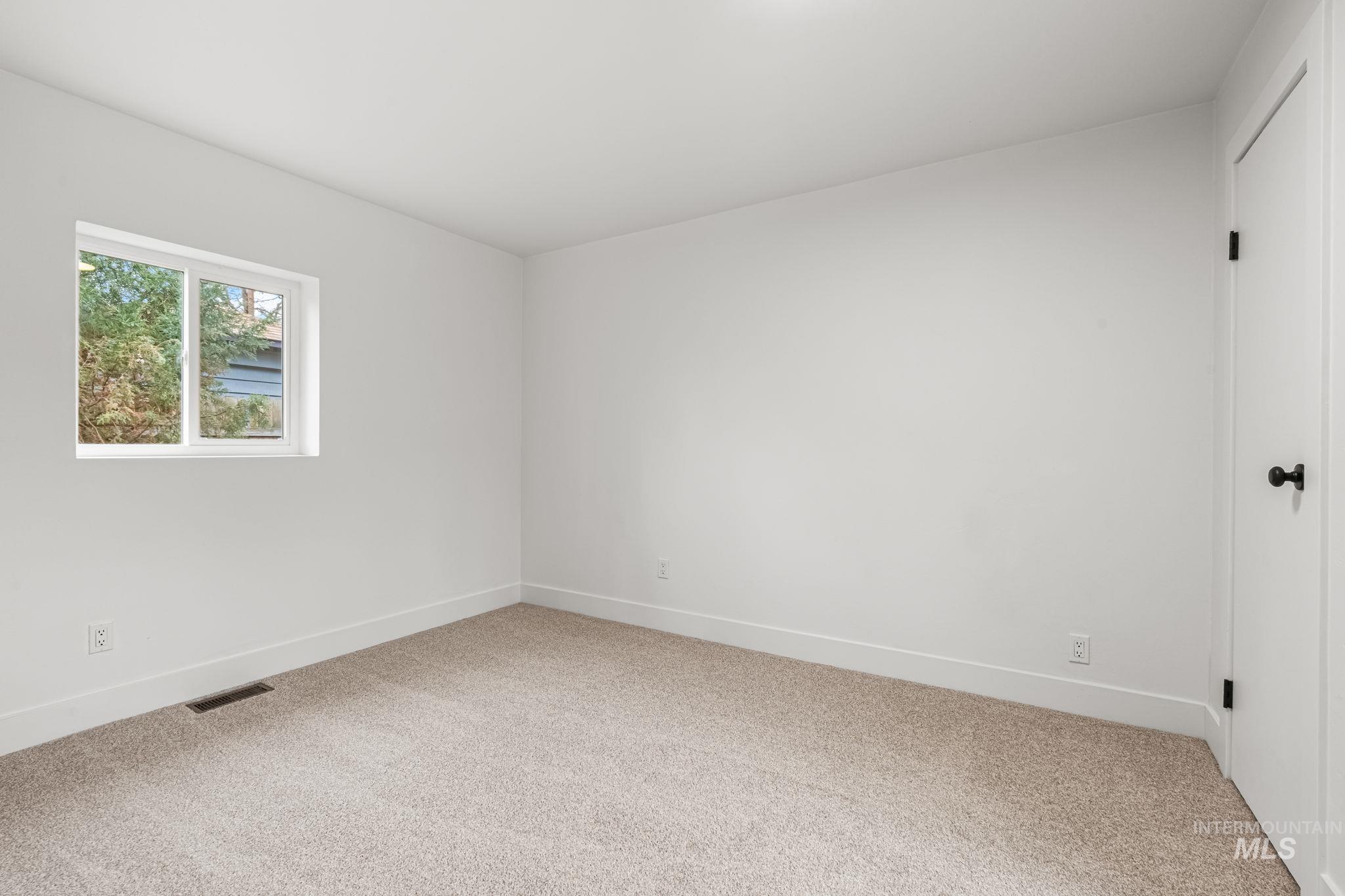 5420 Anna Street Boise, ID 83705 - Photo 21 of 24 Empty room featuring light carpet and baseboards