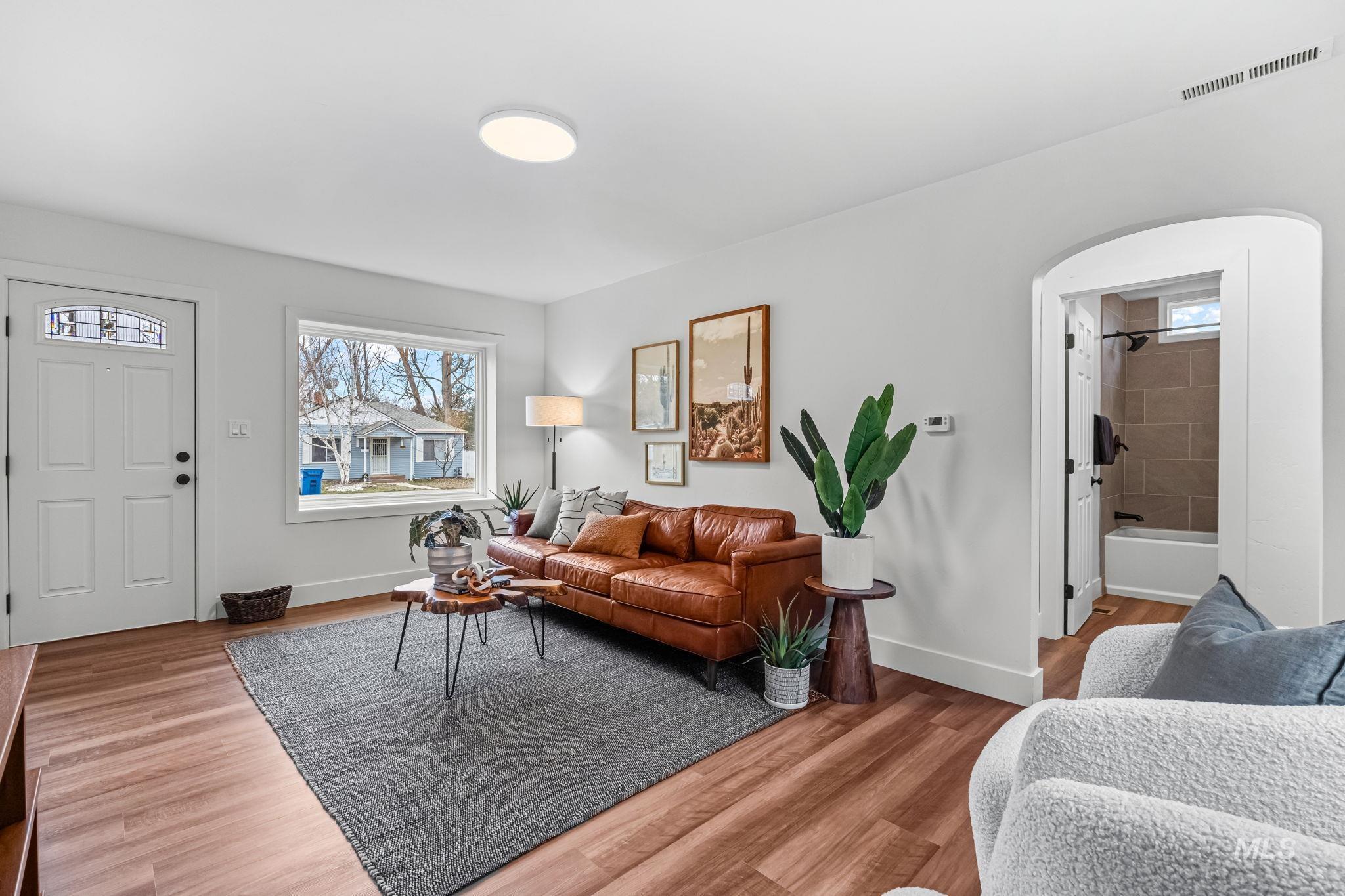5420 Anna Street Boise, ID 83705 - Photo 6 of 24 Living area featuring arched walkways and wood finished floors