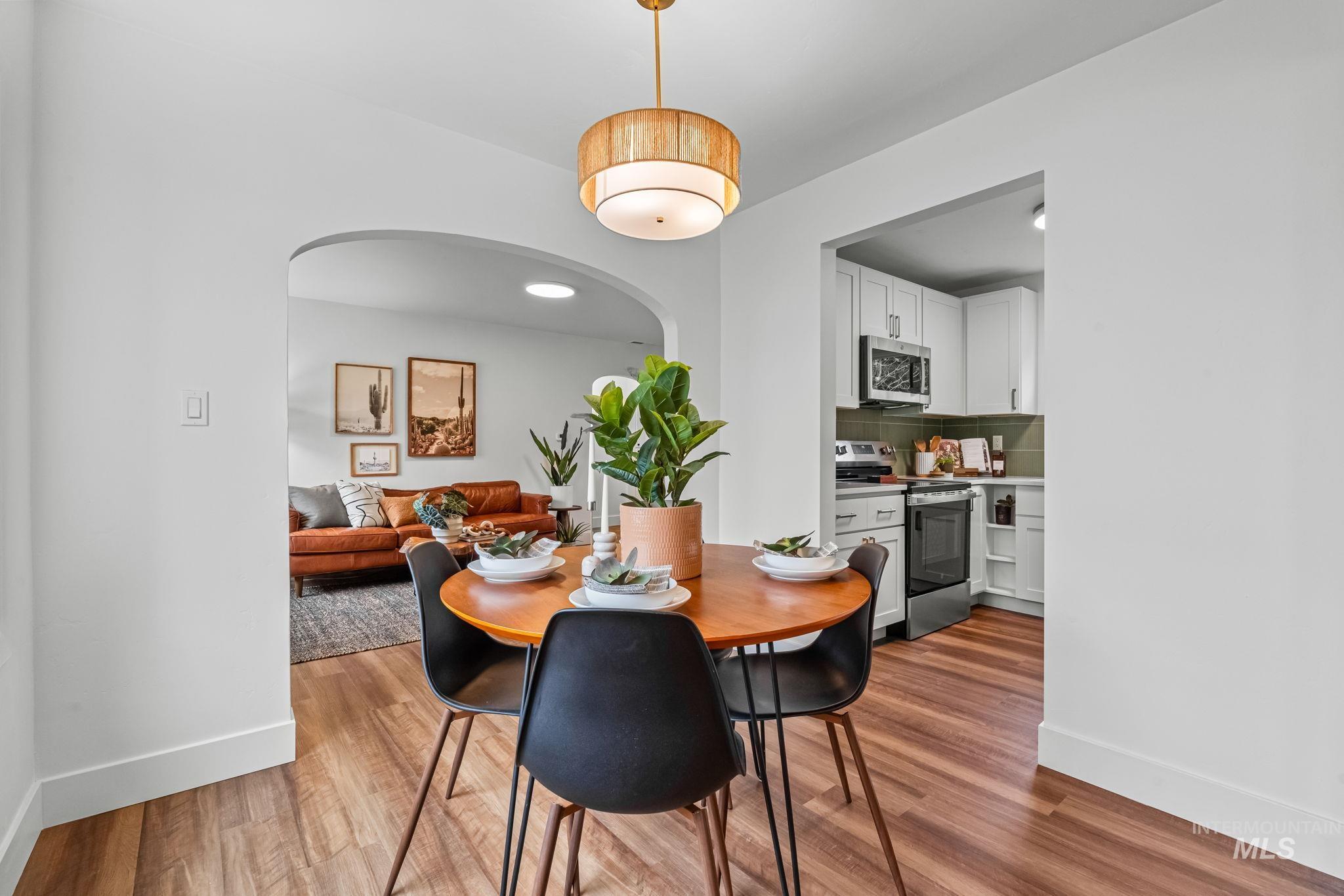 5420 Anna Street Boise, ID 83705 - Photo 9 of 24 Dining area with arched walkways and wood finished floors