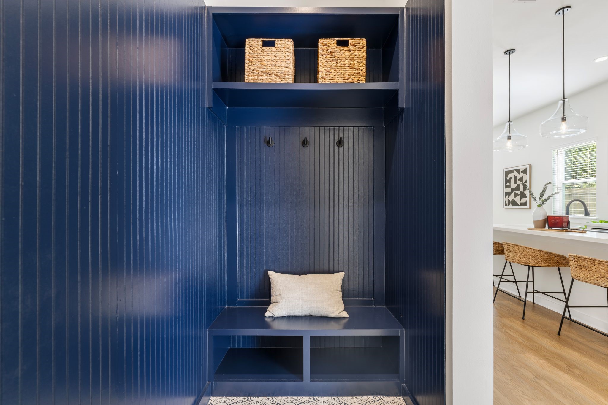 1215 Sampson Street Houston, TX 77003 - Photo 16 of 35 The elegantly designed mudroom with wainscoting, a bench, and cubbies offers practical yet stylish storage solutions. Located at the home's entryway.