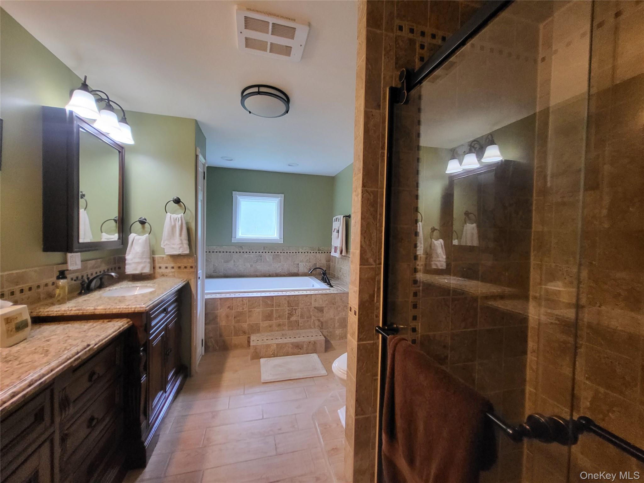 286 Dingle Daisy Road Monticello, NY 12701 - Photo 21 of 35 a spacious bathroom with a double vanity sink and a mirror