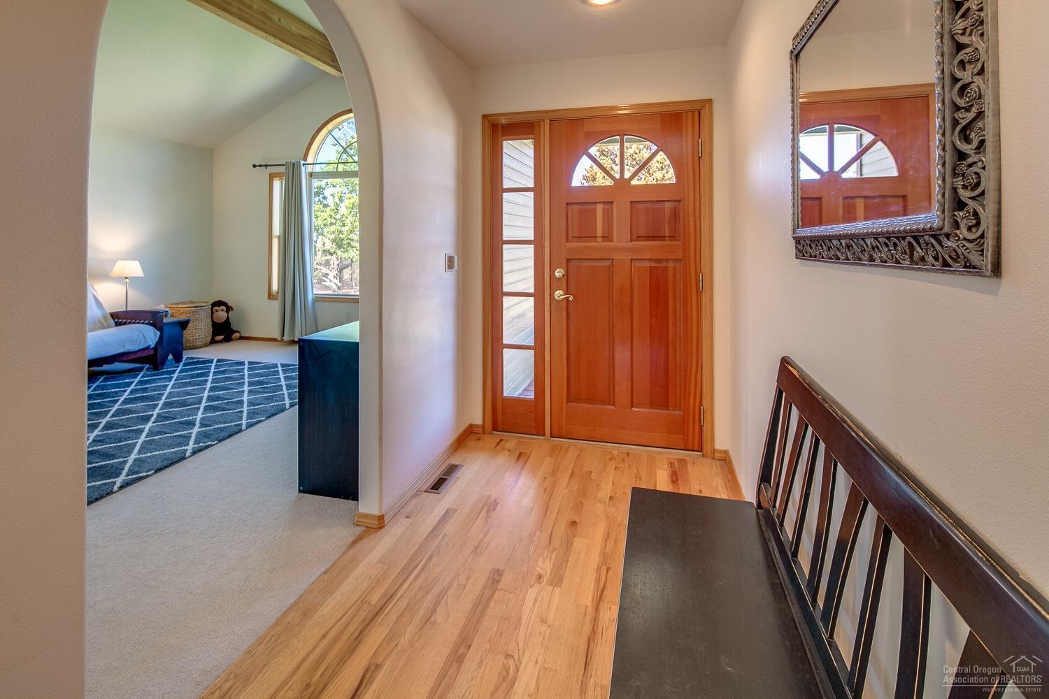 13990 South Sego Lily Road Powell Butte, OR 97753 - Photo 5 of 24 Wood front door with sidelights allows t