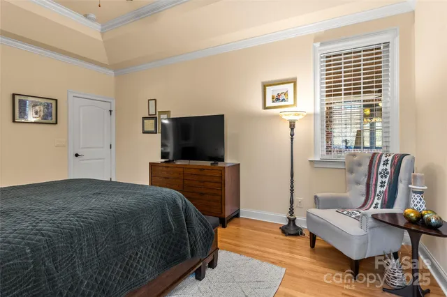 a bedroom with furniture and a flat screen tv