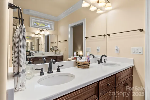 a bathroom with double vanity sinks a vanity and a mirror
