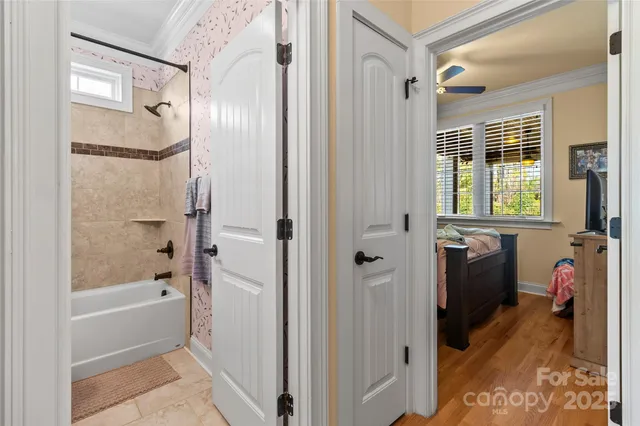 a bathroom with a tub shower and a sink