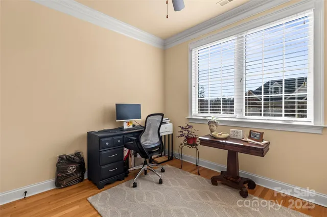 a view of a workspace with furniture and a window