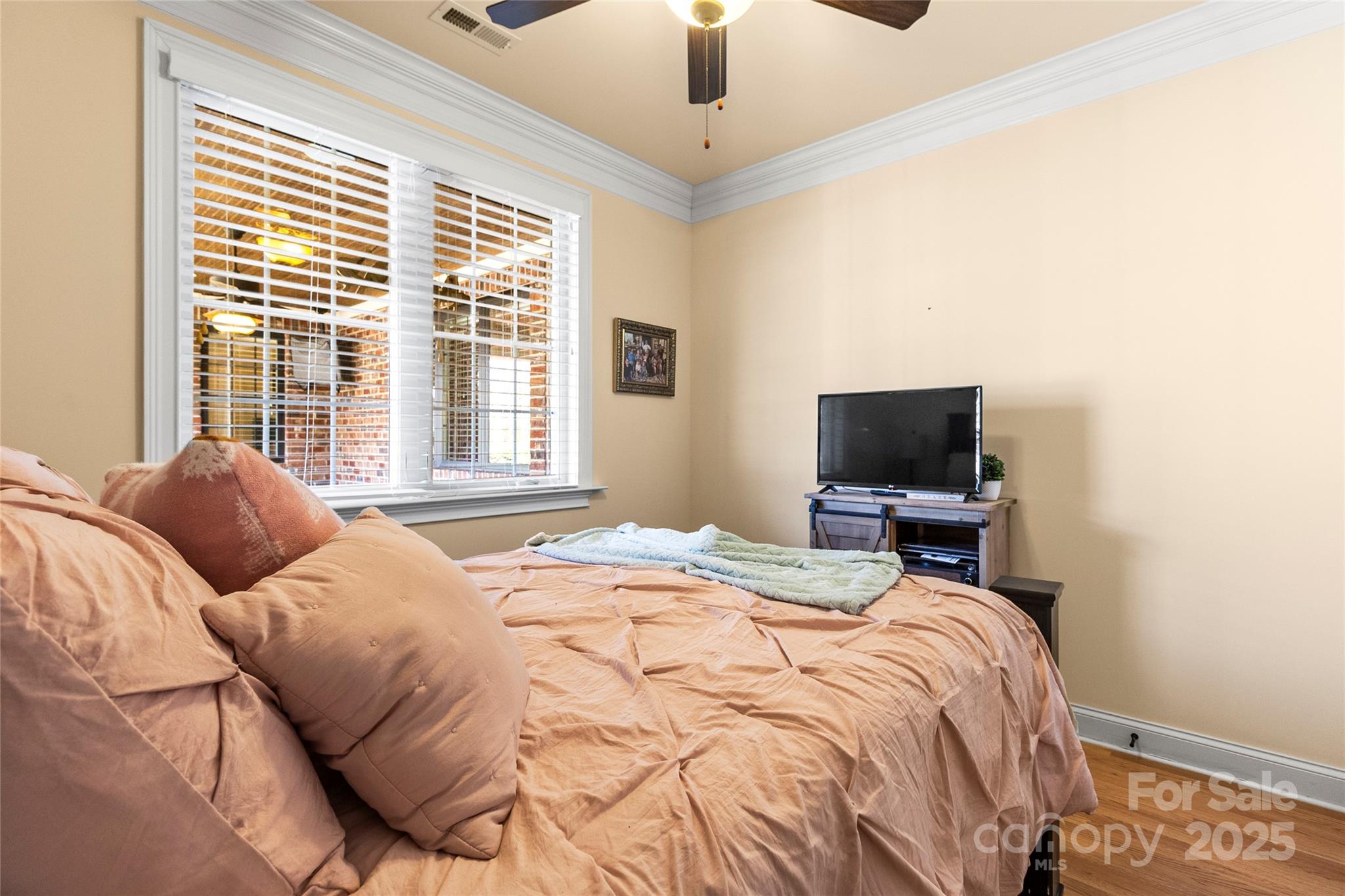 6197 Gold Springs Way Denver, NC 28037 - Photo 32 of 47 a bedroom with a bed a flat screen tv and a chandelier
