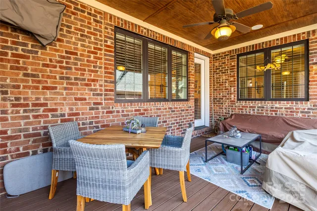 a outdoor dining space with furniture and chandelier