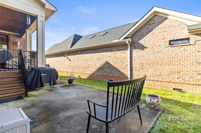 a view of a porch with furniture and a yard