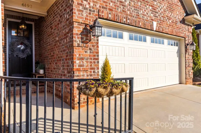 a view of a brick house with a small yard