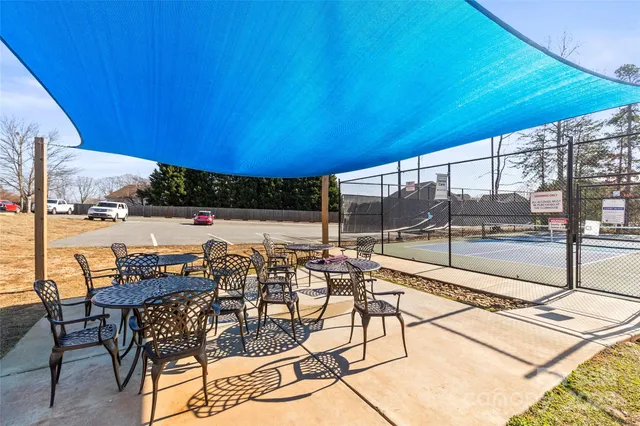 a view of a patio with a table and chairs under an umbrella