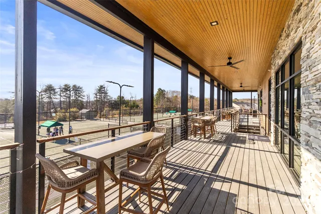 a view of balcony with wooden floor and outdoor seating