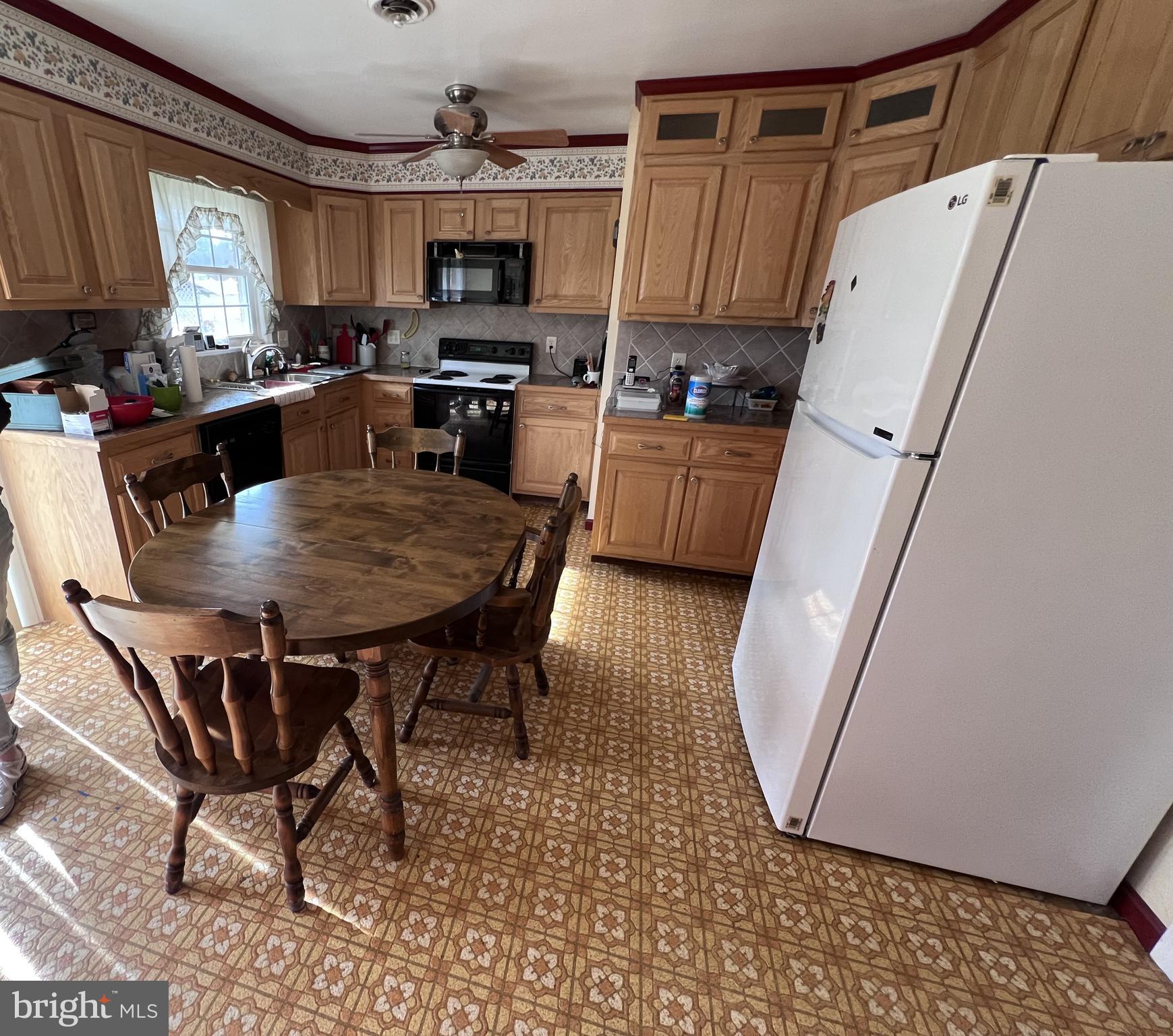 7119 Academy Road Warrenton, VA 20187 - Photo 2 of 21 a kitchen with kitchen island a dining table and chairs