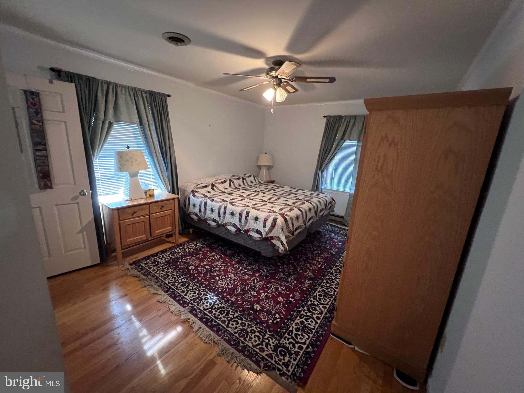 7119 Academy Road Warrenton, VA 20187 - Photo 9 of 21 a bed sitting in a bedroom next to a window
